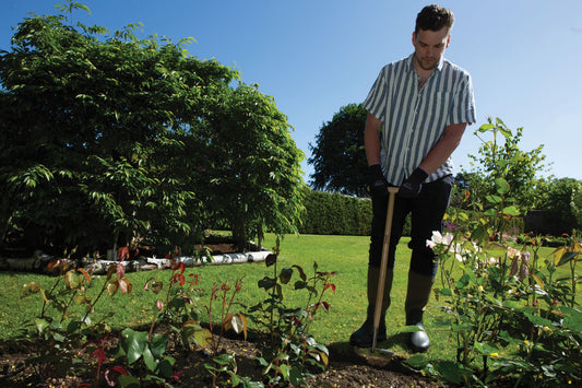 A man using the Wilkinson Sword Lawn Edging Blade with stainless steel head for creating sharp turf edges