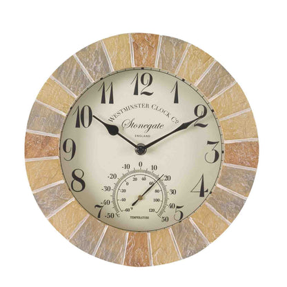 A round wall clock with a textured stone-look outer ring in beige and brown tones, a cream-colored center dial, black Arabic numerals, and a small temperature gauge at the bottom. The brand name 'Windsor Clock Co' and line 'Stonegate' are visible on the face.