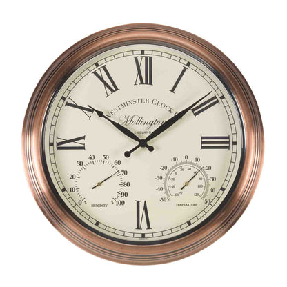 A round wall clock with a copper-toned metal frame, an off-white dial, Roman numerals, black hands, and built-in humidity and temperature gauges. The brand name Wellington is printed on the dial.