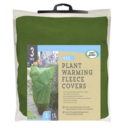 Reusable garden plant warming fleece covers with drawstring providing frost, wind and pest protection for outdoor plants