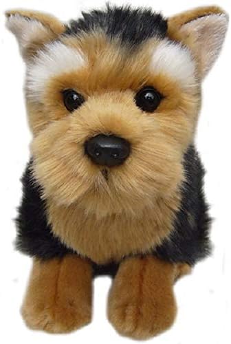A plush toy dog with a black, tan, and white fur pattern, featuring large black eyes and a black nose, set against a plain white background.