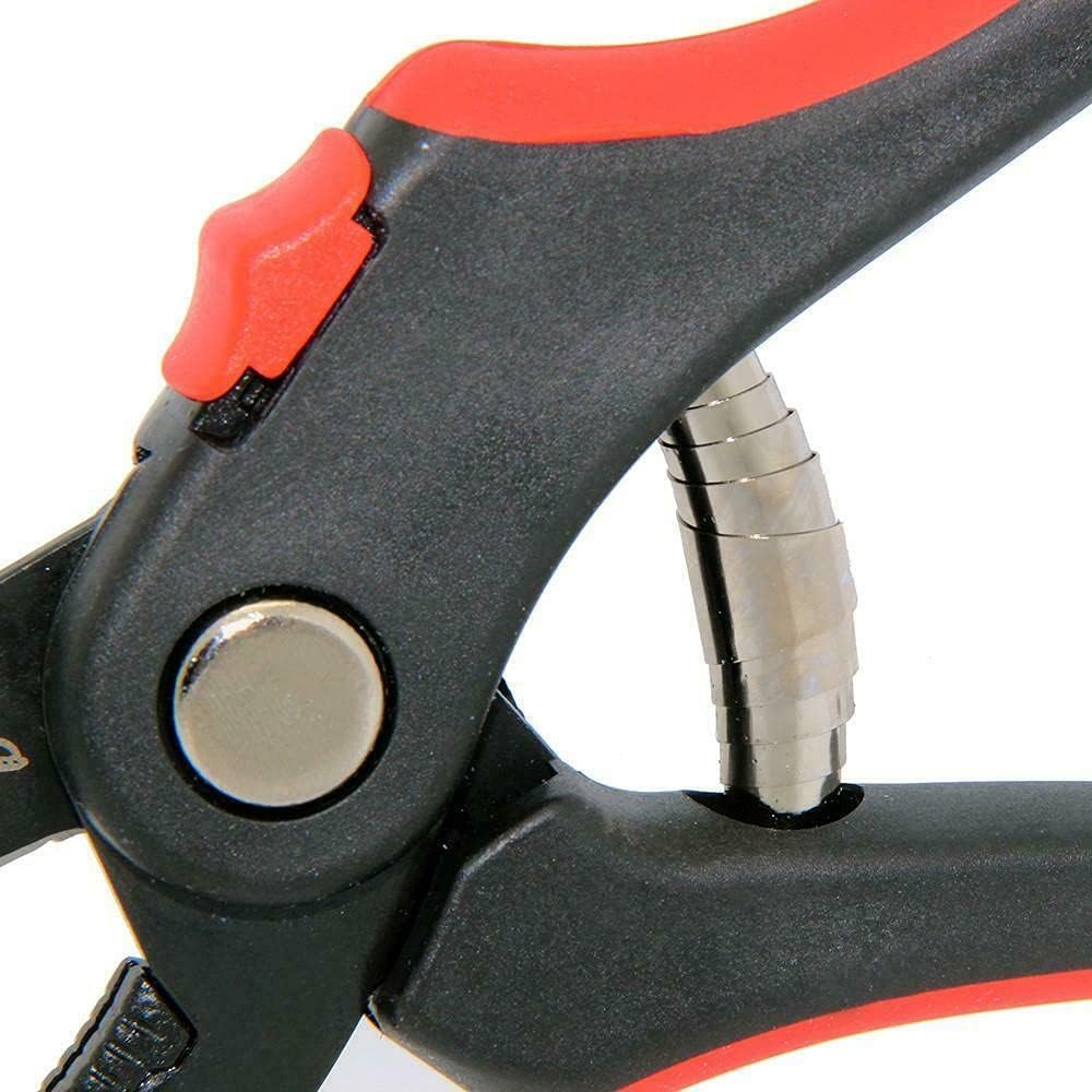 Close-up of a black and red tool with metallic components on a white background