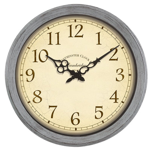 A round wall clock with a distressed gray wood-look frame, a cream-colored face, and black Arabic numerals. The brand name 'Cambridge' is printed on the dial, along with 'Cambridge Clock'.