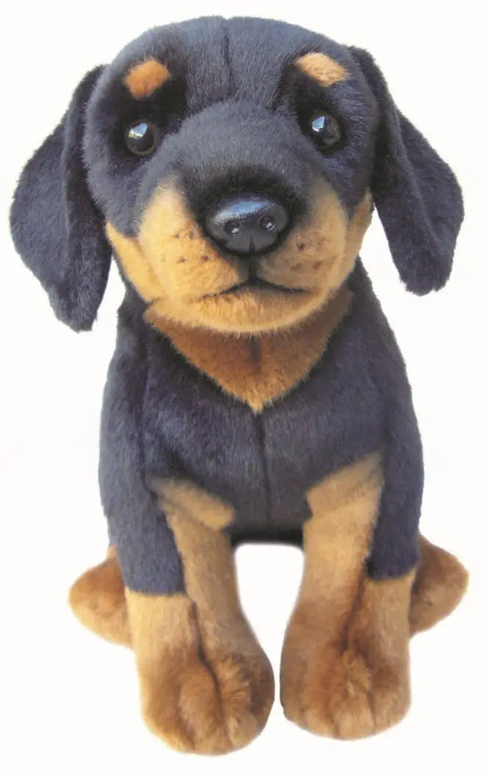A plush stuffed dog puppy toy with a black and tan coloration, sitting against a plain white background.