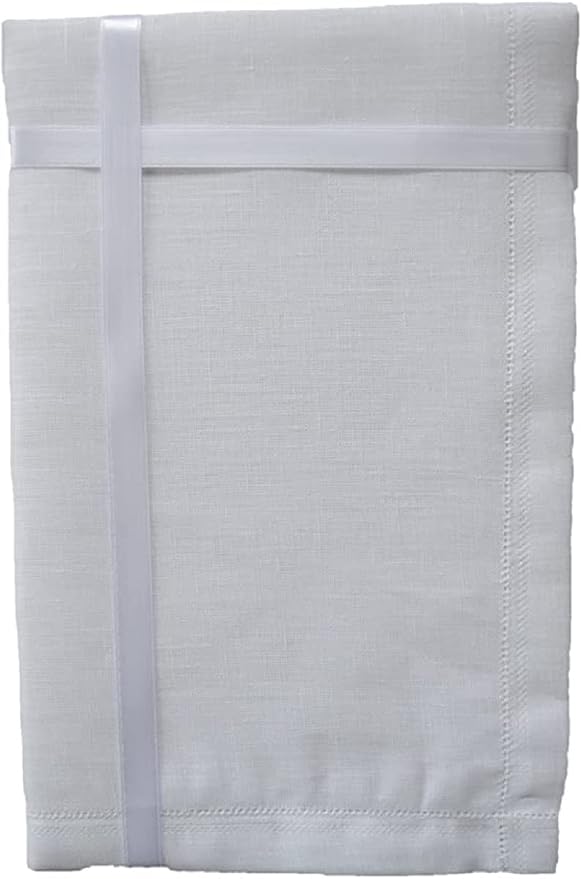 A folded white linen table linen or napkin with a stitched border and a matching white elastic band wrapped around it, shown on a plain white background.