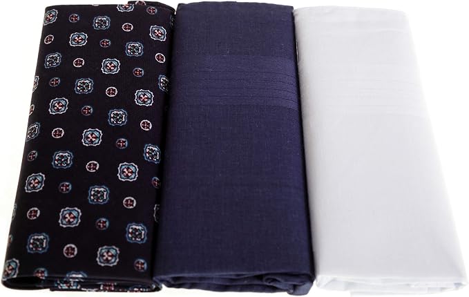 Three folded fabric pieces displayed side by side on a white background: a black fabric with a small repeating multicolor floral pattern, a dark navy fabric, and a plain white fabric.