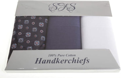 A 3-pack of men's cotton handkerchiefs in a clear plastic clamshell package with a gray cardboard insert. The set includes a dark gray/black handkerchief with a small geometric pattern, a solid navy blue handkerchief, and a solid white handkerchief.