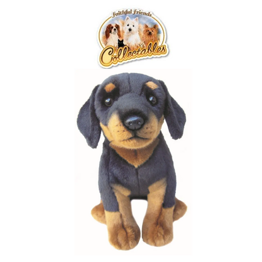 A collectible plush toy of a dachshund puppy, featuring dark charcoal gray and tan fur, sitting against a plain white background with a 'Collectables' brand logo sticker above its head.
