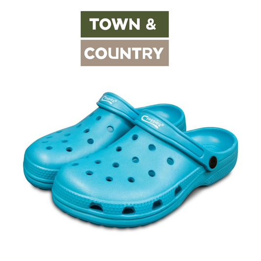 A pair of bright turquoise blue Crocfoot clogs with ventilation holes, displayed on a white background with a 'TOWN & COUNTRY' brand overlay at the top.