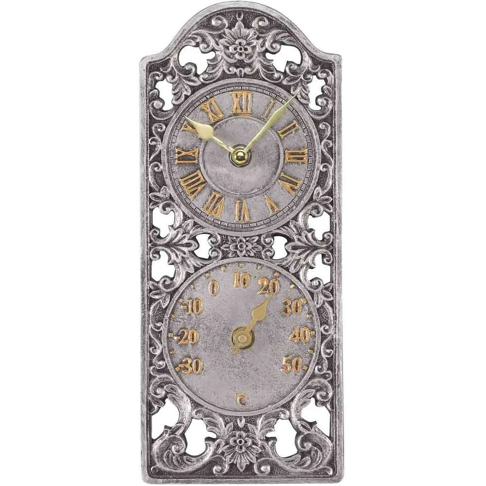 An ornate vintage-style wall clock with a decorative silver-toned metal frame, featuring two circular dials with gold Roman numerals and gold hands on a white background.