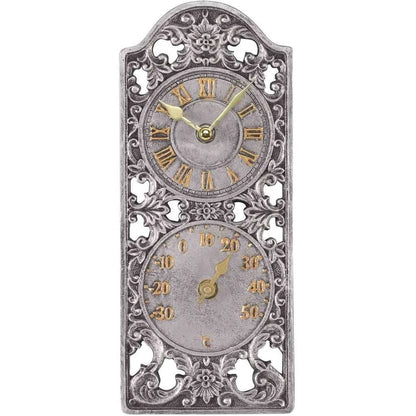 An ornate vintage-style wall clock with a decorative silver-toned metal frame, featuring two circular dials with gold Roman numerals and gold hands on a white background.